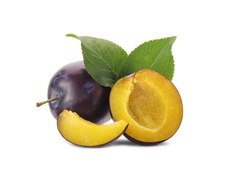 Whole and halves of purple plums with leaves isolated on white background.
