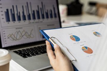 A woman holding a sales summary, the sales manager is looking at the monthly sales summary document and summarizing it to pay the salesperson commissions. Sales management concept.