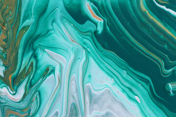 art photography of abstract marbleized effect background with white, green and gold creative colors. Beautiful paint.