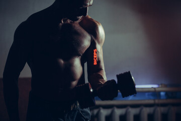 Fototapeta na wymiar Young Adult Man Working Out Biceps with Dumbbell with word on his hand.