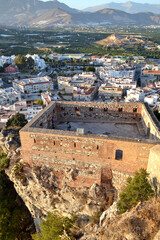 Fototapeta premium Aerial view of part of the castle of Salobreña with a landscape in the background formed by houses and mountains