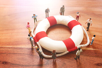 Concept image of life buoy protecting group of people. Rescue and support in times of crisis...