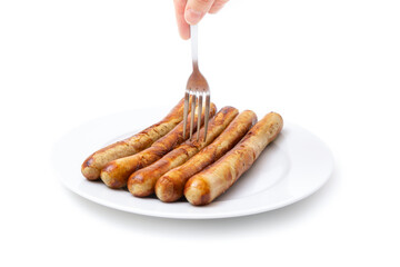 Spearing a grilled german sausage with a fork