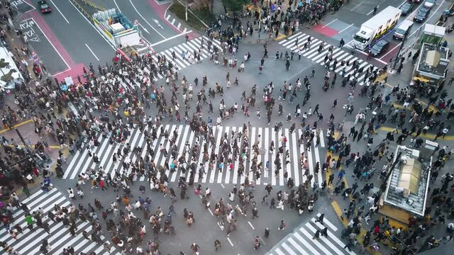 POV of many people walking crossing road in shibuya street area in daytime before covid19 outbreak in slowmotion