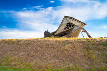 Dilapidated wood barn seen from the rural wheat fields