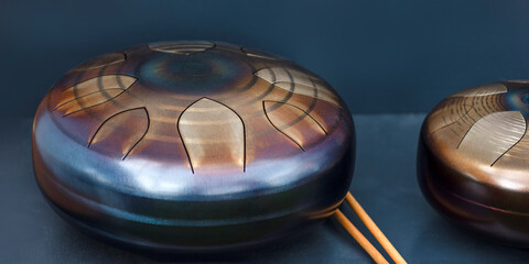 Steel tongue, drum. Singing bowl, steel drum and drumsticks. Instrument for sound wave therapy and...
