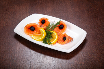Sliced salmon snack with lemon