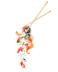 Two fresh sushi rolls with ingredients in the air on a white background