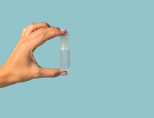 Plastic white container with medicine. Close-up on a blue background.