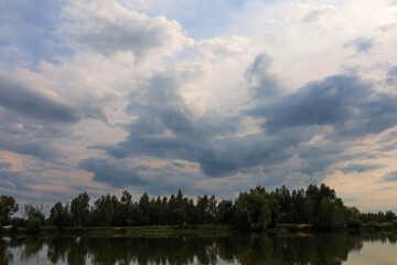 sandy lake in the forest on the background of the sky evening time