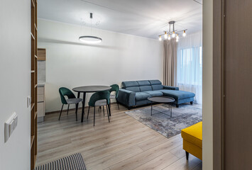 Modern light interior of living room in studio apartment. Furniture.