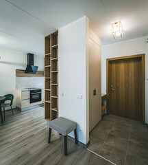 Modern interior of new apartment. Beige kitchen. Entrance hall.