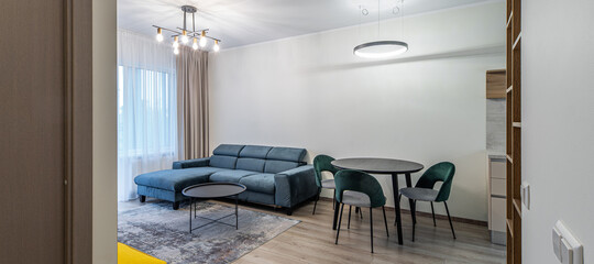 Modern light interior of living room in studio apartment. Furniture.