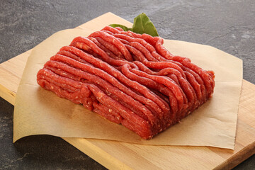 Raw beef minced meat over board