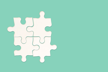White jigsaw puzzle on green background, Find the right joined team and fit correctly concept