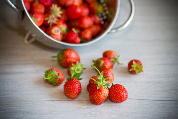 red ripe natural strawberries on a wooden table