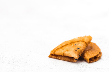 Delicious crispy coconut folded on white background for Thai dessert, asian food and eating concept