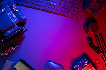 Flat lay of computer parts and video camera on illuminated table