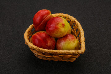 Sweet small nectarines in the basket