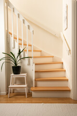 A white and wooden indoor staircase at a house.