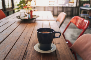 Close up of hand holding a cup of hot cocoa in a cafe.