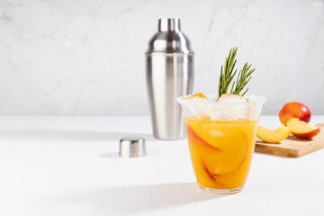 Cooking of refreshing juicy peach cocktail with ice, rosemary, sugar rim in misted glass,...
