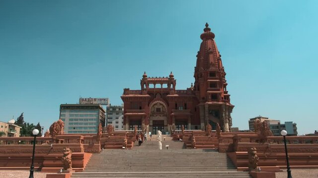 Baron Empain Palace (Le Palais Hindou)  in Cairo, Egypt exterior daylight zooming and panning shot showing the unique architecture of the palace with visitors walking