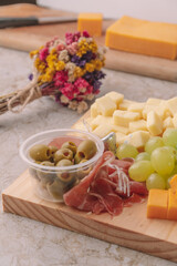 olives detail on a chesee platter on a marble table