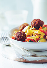 Pappardelle Pasta with Meatballs and fresh Basil on bright background. Close up.
