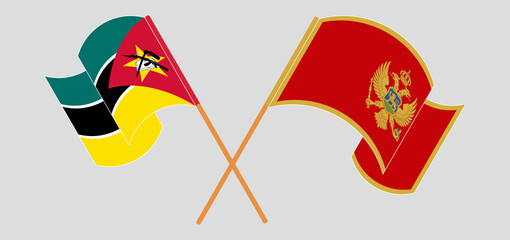Crossed and waving flags of Mozambique and Montenegro