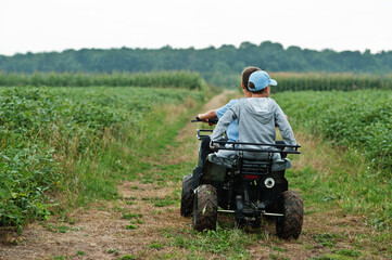 Two brothers driving four-wheller ATV quad bike. Happy children moments. © AS Photo Family