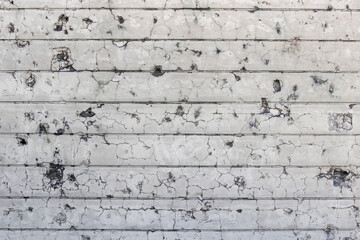 Concrete wall background with bullet holes. Cracked concrete texture closeup background. Wall...