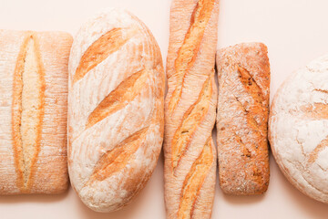 Lots of different fresh breads on a light background. Fragrant airy baked goods. Sliced ​​bread.
