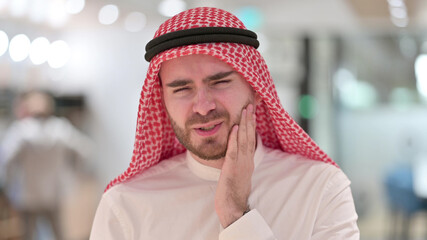 Portrait of Unhealthy Young Arab Businessman having Toothache