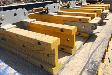 Stacked formwork made of yellow wooden beams using for concrete cast in place works - obrazy, fototapety, plakaty