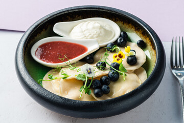 Dumplings with white cheese and blueberries, delicious and healthy dinner or dessert.