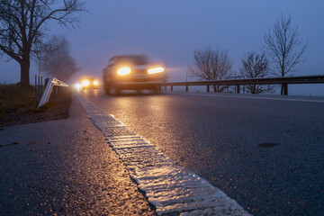 Lighted cars at dusk on  main road