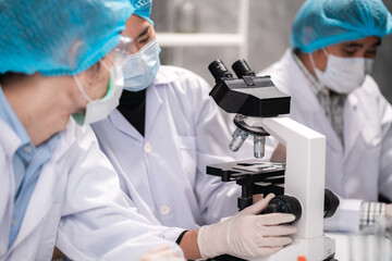 Fototapeta premium Health care researchers working in life science laboratory, medical science technology research work for test a vaccine, coronavirus covid-19 vaccine protection cure treatment