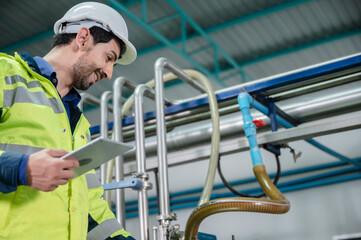 technician engineer working to maintenance a construction equipment industry, production technology in plant factory, man working to safety control system in manufacturing product factory