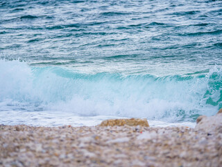 Waves on the beach with bays and rocks in Croatia