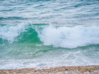 Waves on the beach with bays and rocks in Croatia