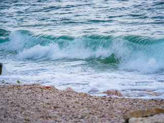 Waves on the beach with bays and rocks in Croatia