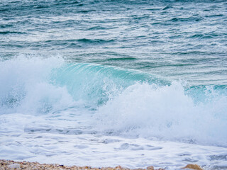 Waves on the beach with bays and rocks in Croatia
