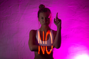 Young adult woman with word NO on her body.