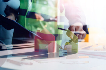 Construction engineer working at blueprint to build large commercial buildings in office. Engineering tools and construction concept.