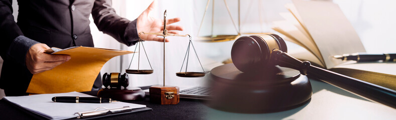 Justice and law concept.Male judge in a courtroom with the gavel, working with, computer and...