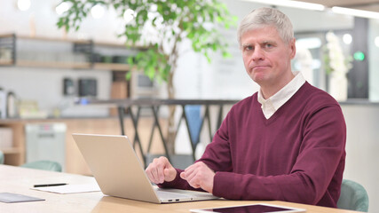Rejecting Middle Aged Businessman Looking at Camera