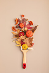 Flat lay with fall decoration and paint brush. Autumn holidays, thanksgiving, halloween geeting...