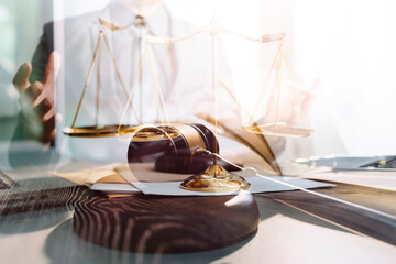 Business and lawyers discussing contract papers with brass scale on desk in office. Law, legal services, advice, justice and law concept picture with film grain effect