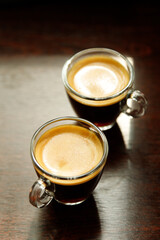 two glass coffee cup with espresso near the window in morning
